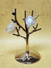 Load image into Gallery viewer, Two miniature Christmas ornament baubles in a clear color with silvery white swirls inside. The earrings are shown before being attached to hooks, and are hanging on a small, silver, leafless tree stand.
