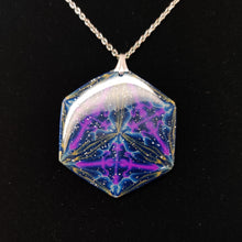 Load image into Gallery viewer, Light reflecting off a large glossy hexagonal pendant displayed on a black velvet background. The pendant is navy blue with veins of gold around the edges and radiating from the center in thirds. There are purple veins in the relative shape of a triangle throughout the pendant.