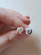 Load image into Gallery viewer, Purple, gold and white swirl earrings held between finger and thumb
